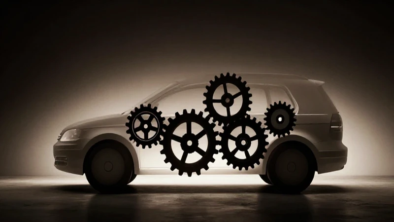 Siluetas Volkswagen con engranajes bajo luz dramática