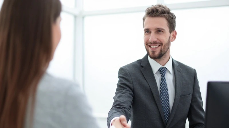Empleado sonriente saluda al cliente con confianza
